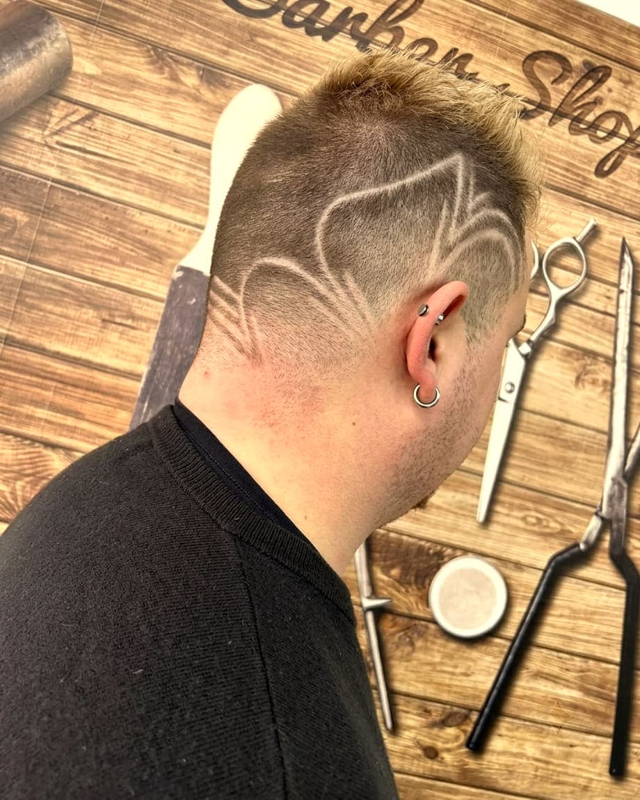A blond crop with a freehand pattern shaved into the side and back